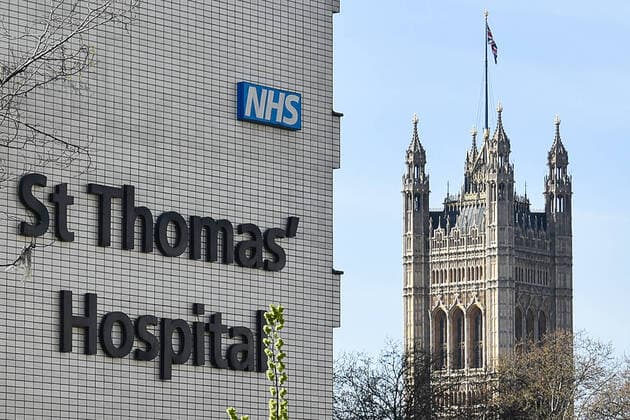 LONDON, UNITED KINGDOM - APRIL 7, 2020: An outside view of St Thomas Hospital where British Prime Minister Boris Johnson is being treated for the novel coronavirus (COVID-19) infection. The prime minister was admitted to the hospital on 5 April and taken to intensive care on the next day. Seen in the distance is Victoria Tower of the Houses of Parliament (Westminster Palace). Ilya Dmitryachev TASS  TS0D4C07