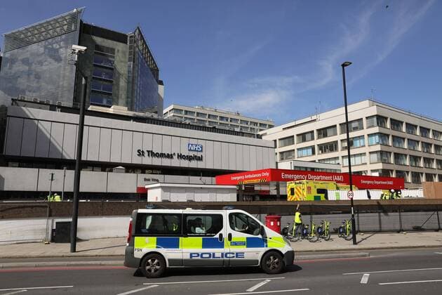 (200407) -- LONDON, April 7, 2020 (Xinhua) -- A police van drives past St. Thomas Hospital, where British Prime Minister Boris Johnson remains in care after being admitted with coronavirus symptoms, in London, Britain, April 7, 2020. British Prime Minister Boris Johnson was taken to intensive care on Monday night after his coronavirus symptoms worsened, Downing Street said. The prime minister, 55, was admitted to St Thomas Hospital in London with persistent symptoms on Sunday night, 10 days after testing positive for coronavirus. (Photo by Tim Ireland Xinhua) BRITAIN-LONDON-COVID-19-BORIS JOHNSON-HOSPITAL