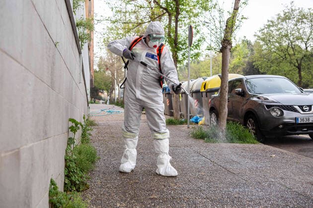 April 7, 2020, Girona, Spain: A civil protection agent dressed in a protective suit sprays disinfectants on the streets in front of Centre residencial Gerunda..During the Covid-19 crisis, the civil protection agents of Gerona carry out disinfection tasks in the residences for the elderly. Girona Spain - ZUMAs197 20200407_zaa_s197_044 Copyright: xMartixNavarrox