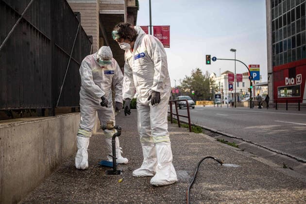 April 7, 2020, Girona, Spain: Civil protection agents dressed in protective suits fix a water hose..During the Covid-19 crisis, the civil protection agents of Gerona carry out disinfection tasks in the residences for the elderly. Girona Spain - ZUMAs197 20200407_zaa_s197_049 Copyright: xMartixNavarrox