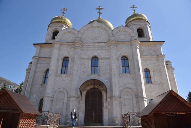 STAVROPOL TERRITORY, RUSSIA - APRIL 7, 2020: A Russian Orthodox believer at the entrance to the Cathedral of Christ the Saviour Healing An Infirm Man At The Pool of Bethesda, on the feast day of the Annunciation, in the city of Pyatigorsk. Anton Podgaiko TASS  TS0D4B1A