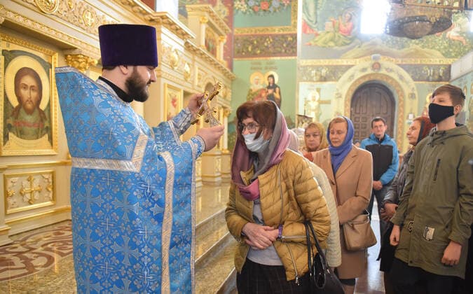 STAVROPOL TERRITORY, RUSSIA - APRIL 7, 2020: A Russian Orthodox priest holds a cross to bless believers after a service in the Cathedral of Christ the Saviour Healing An Infirm Man At The Pool of Bethesda, on the feast day of the Annunciation, in the city of Pyatigorsk, during the pandemic of the novel coronavirus (COVID-19). Anton Podgaiko TASS  TS0D4B28