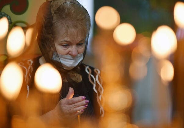 STAVROPOL TERRITORY, RUSSIA - APRIL 7, 2020: A Russian Orthodox believer in a face mask attends a service in the Cathedral of Christ the Saviour Healing An Infirm Man At The Pool of Bethesda, on the feast day of the Annunciation, in the city of Pyatigorsk, during the pandemic of the novel coronavirus (COVID-19). Anton Podgaiko TASS  TS0D4B7F