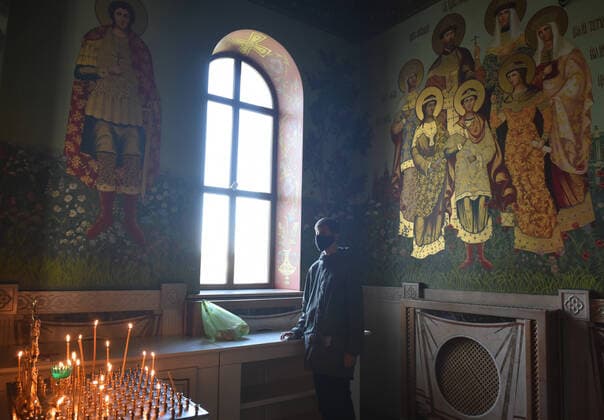 STAVROPOL TERRITORY, RUSSIA - APRIL 7, 2020: A Russian Orthodox believer in a face mask attends a service in the Cathedral of Christ the Saviour Healing An Infirm Man At The Pool of Bethesda, on the feast day of the Annunciation, in the city of Pyatigorsk, during the pandemic of the novel coronavirus (COVID-19). Anton Podgaiko TASS  TS0D4B83