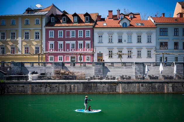 April 7, 2020, Ljubljana, Slovenia: A stand up paddler is seen on Ljubljanica river, next to the Cankarjevo nabrezje in city centre of Ljubljana..Slovenia entered into 4th week of quarantine amidst the coronavirus outbreak..Slovenia Health Ministry recorded a total of 1,059 infections, 36 death and 102 recovered since the beginning of the Coronavirus (Covid-19) outbreak. Ljubljana Slovenia - ZUMAs197 20200407_zaa_s197_121 Copyright: xJurexMakovecx