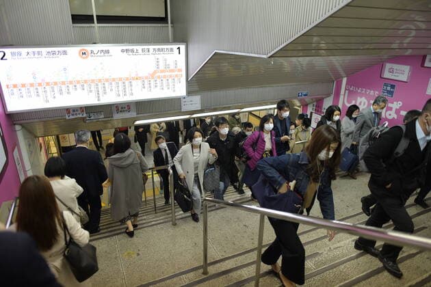 TOKYO, JAPAN - APRIL 7: Commuters wearing masks walk in a subway in Tokyo, Tuesday, April 7, 2020, in Tokyo. Japanese Prime Minister Shinzo Abe declared a state of emergency on Tuesday for Tokyo and six other prefectures to ramp up defenses against the spread of the coronavirus. (Photo: Richard Atrero de Guzman AFLO)  (125133561)