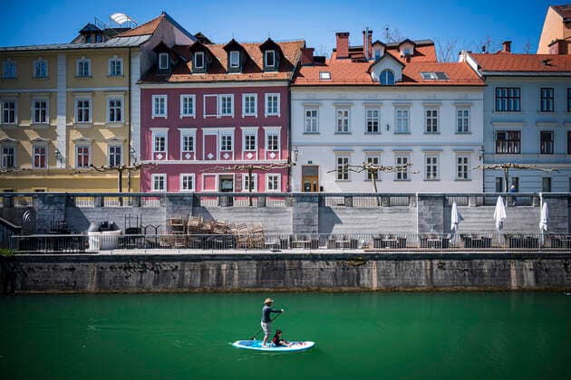 April 7, 2020, Ljubljana, Slovenia: A stand up paddler is seen on Ljubljanica river, next to the Cankarjevo nabrezje in city centre of Ljubljana. Slovenia entered into 4th week of quarantine amidst the coronavirus outbreak. Slovenia Health Ministry recorded a total of 1,059 infections, 36 death and 102 recovered since the beginning of the Coronavirus (Covid-19) outbreak. Ljubljana Slovenia - ZUMAs197 20200407_zaa_s197_121 Copyright: xJurexMakovecx