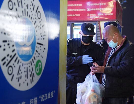 (200408) -- WUHAN, April 8, 2020 -- A staff member helps a passenger scan health codes at Wuchang Railway Station in Wuhan, central China s Hubei Province, April 8, 2020. Wuhan, the megacity in central China, started lifting outbound travel restrictions from Wednesday after almost 11 weeks of lockdown to stem the spread of COVID-19. ) CHINA-HUBEI-WUHAN-OUTBOUND TRAVEL RESTRICTIONS-LIFT (CN) LixHe 
