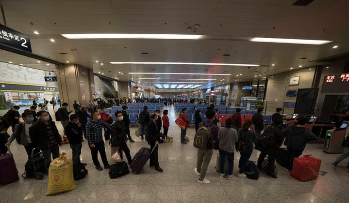 (200408) -- WUHAN, April 8, 2020 -- Passengers line up to wait for train K81 at Wuchang Railway Station in Wuhan, central China s Hubei Province, early April 8, 2020. The train K81, which started from Xi an of northwest China s Shaanxi Province and is heading for Guangzhou in south China s Guangdong Province, made a stop to pick up 442 passengers at Wuchang Railway Station in Wuhan early Wednesday, the first one since the city lifted its outbound travel restrictions. ) CHINA-HUBEI-WUHAN-OUTBOUND TRAVEL RESTRICTIONS-LIFT (CN) FeixMaohua 