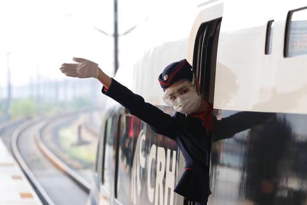 (200408) -- WUHAN, April 8, 2020 -- A stewardess waves to passengers on train G431 before departure in Wuhan, capital of central China s Hubei Province, April 8, 2020. Train G431 from Wuhan to Nanning of south China s Guangxi Zhuang Autonomous Region, the first outbound train leaving Hubei Province from Wuhan since the outbound travel restrictions were lifted, reopened its service on Wednesday. Wuhan lifted outbound travel restrictions from Wednesday after almost 11 weeks of lockdown to stem the spread of COVID-19. ) CHINA-HUBEI-WUHAN-FIRST OUTBOUND TRAIN LEAVING HUBEI (CN) ShenxBohan 