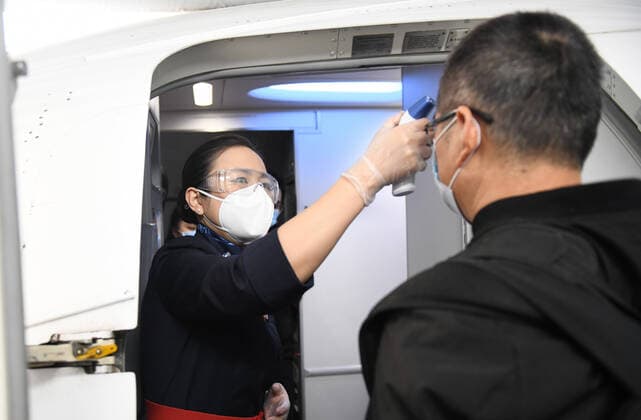 (200408) -- WUHAN, April 8, 2020 -- A passenger receives body temperature check before boarding flight MU2527 of China Eastern airlines at the Tianhe International Airport in Wuhan, central China s Hubei Province, April 8, 2020. Wuhan on Wednesday lifted outbound travel restrictions, after almost 11 weeks of lockdown to stem the spread of COVID-19. ) CHINA-HUBEI-WUHAN-OUTBOUND TRAVEL RESTRICTIONS-LIFTING (CN) ChengxMin 