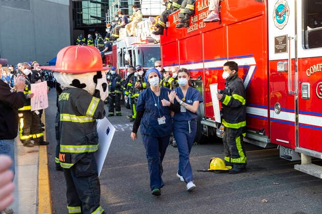 NY: Nassau County first responders salute medics Nassau County first responders line up to salute heroes from front lines of COVID-19 pandemic at North Shore University Hospital where medical personnel leaves day shift Manhasset New York United States Copyright: LevxRadin