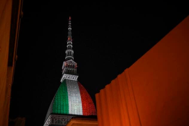 Turin. Intesa SanPaolo and Mole Antonelliana skyscraper with the Italian flag during the lockdown for Covid19 in the photo: Mole Antonelliana  Copyright: xRiccardoxGiordanox xIPAx xFotosickix