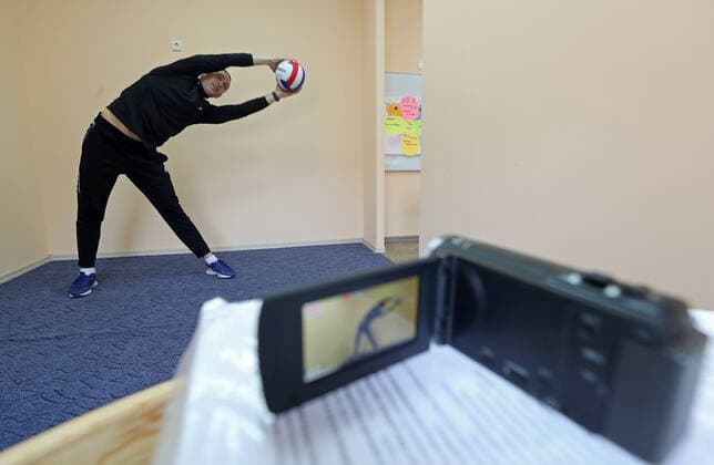 KAZAN, RUSSIA - APRIL 8, 2020: P.E. teacher Mikhail Khramov during an online class at Gymnasium 179. From April 6, 2020, the Kazan schools resumed classes in online format due to the COVID-19 coronavirus pandemic. Yegor Aleyev TASS  TS0D4D38