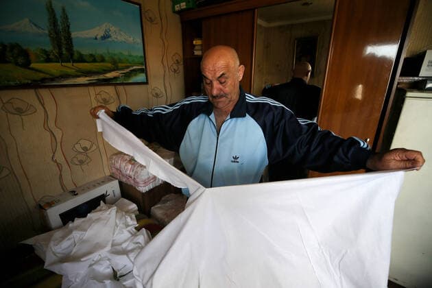 SOCHI, RUSSIA - APRIL 8, 2020: Gamlet Barsegyan cutting fabric for face masks. The Barsegyans receive materials from the Sochi city hall, sew face masks and give them to volunteers and healthcare workers attending patients under quarantine. Dmitry Feoktistov TASS  TS0D4DA1