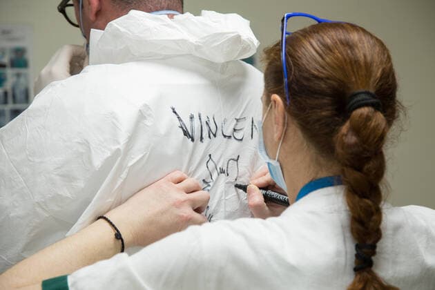 Rome: Dressing of nurses in a COVID-19 Hospital Writing of the name of the nurse who must enter the area hosting the ICU patients Dressing procedures for nurses in the clean area of pavilion D of the San Filippo Neri hospital in Rome, used as a Covid hospital Roma RM Italy Copyright: MatteoxNardone