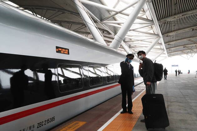 (200408) -- GUANGZHOU, April 8, 2020 -- A passenger gets off the train G1005 and leaves the Guangzhou South Railway Station under the help of a staff member in Guangzhou, south China s Guangdong Province, April 8, 2020. G1005, the first train that departed from Wuhan to Guangdong Province since Wuhan lifted outbound travel restrictions arrived at Guangzhou South Railway Station on Wednesday. The train was destined for Shenzhen. ) CHINA-GUANGZHOU-TRAIN FROM WUHAN-ARRIVAL (CN) LuxYe 