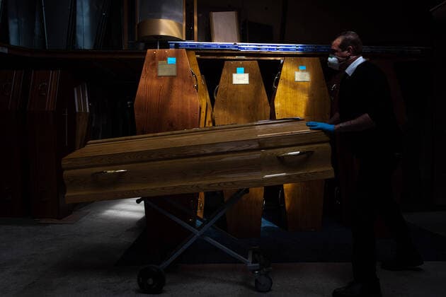 Paris, France, April 7, 2020 - Report inside the Santilly Funeral Home, which is currently facing the Coronavirus epidemic (Covid-19) - A funeral home attendant is carrying a coffin marked Covid-19 among many others.  Copyright: xAlexisxSciardx