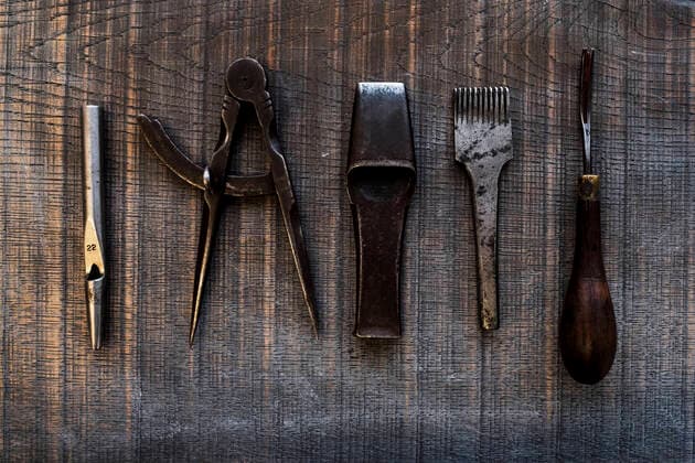 High angle close up of selection of saddle making hand tools. High angle close up of selection of saddle making hand tools.,Farm  60667