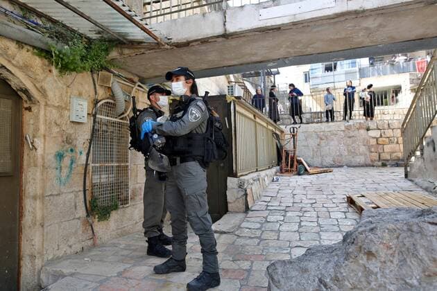 (200408) -- JERUSALEM, April 8, 2020 (Xinhua) -- Israeli police officers wearing face masks patrol on a street in Mea Shearim neighborhood in Jerusalem, on April 8, 2020. Israel reported six new death cases from the novel coronavirus, bringing the death toll to 71, the state s Ministry of Health said Wednesday. The ministry added that a total of 9,404 people in Israel were tested positive for COVID-19 so far. (Photo by Gil Cohen Magen Xinhua) MIDEAST-JERUSALEM-COVID-19-CURFEW 