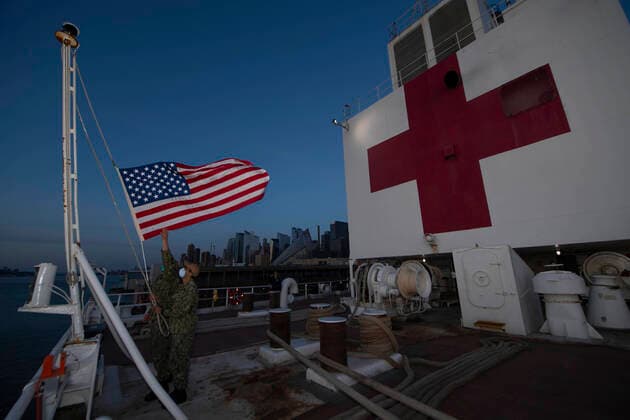 April 6, 2020, New York, NY, United States of America: U.S. Navy sailors lower the flag during the evening ceremony aboard the Military Sealift Command hospital ship USNS Comfort moored at dock at Pier 90 in New York harbor April 6, 2020 in New York City, New York. The Comfort is deploying to the city in support of the nationÃ¢â‚¬â ¢s COVID-19 response efforts. New York United States of America - ZUMAp138 20200406_zaa_p138_044 Copyright: xSaraxEshleman UsxNavyx