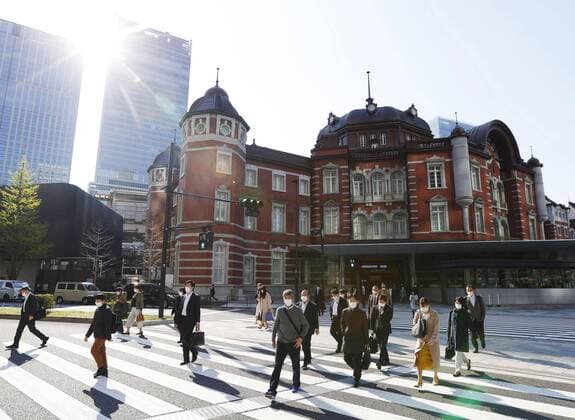 New coronavirus Masked commuters walk in Tokyo s Marunouchi business district on April 9, 2020, amid concerns over the new coronavirus. 