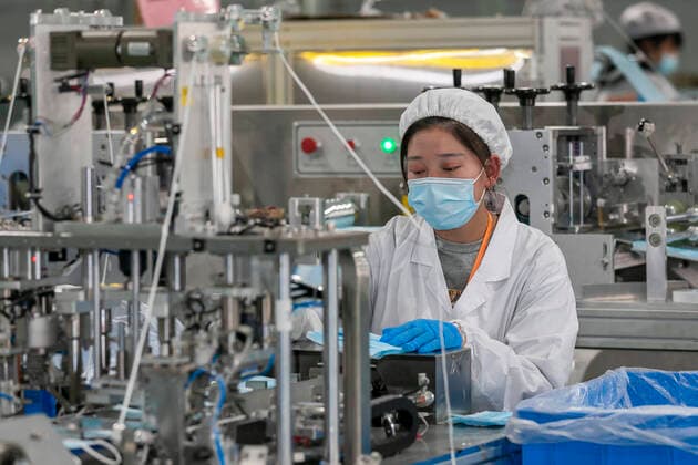 (200409) -- SHANGHAI, April 9, 2020 -- A worker makes protective masks at a mask plant of Chinese underwear brand Threegun Group in Shanghai, east China, April 8, 2020. The mask production of the company has kicked into high gear recently with the daily output reaching one million pieces. (Photo by Xinhua) CHINA-SHANGHAI-MASKS PRODUCTION (CN) WangxXiang 