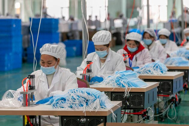 (200409) -- SHANGHAI, April 9, 2020 -- Workers make protective masks at a mask plant of Chinese underwear brand Threegun Group in Shanghai, east China, April 8, 2020. The mask production of the company has kicked into high gear recently with the daily output reaching one million pieces. (Photo by Xinhua) CHINA-SHANGHAI-MASKS PRODUCTION (CN) WangxXiang 