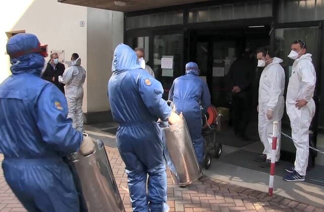 LOMBARDY, ITALY - APRIL 9, 2020: A video screen grab shows servicemen of the Russian Nuclear, Biological and Chemical Protection Troops carrying out disinfection procedures at the Pope John Paul I care home in Seriate to the south-east of Bergamo. As agreed by Russia s President Vladimir Putin and Italy s Prime Minister Giuseppe Conte, 15 military aircraft have arrived in Italy, carrying around 100 Russian military virologists and Defence Ministry experts in epidemiology, eight medical teams for COVID-19 patients and disinfection equipment. Russian Defence Ministry TASS  TS0D4ECD