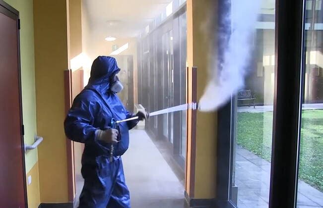LOMBARDY, ITALY - APRIL 9, 2020: A video screen grab shows a serviceman of the Russian Nuclear, Biological and Chemical Protection Troops carrying out disinfection procedures at the Pope John Paul I care home in Seriate to the south-east of Bergamo. As agreed by Russia s President Vladimir Putin and Italy s Prime Minister Giuseppe Conte, 15 military aircraft have arrived in Italy, carrying around 100 Russian military virologists and Defence Ministry experts in epidemiology, eight medical teams for COVID-19 patients and disinfection equipment. Russian Defence Ministry TASS  TS0D4EDA