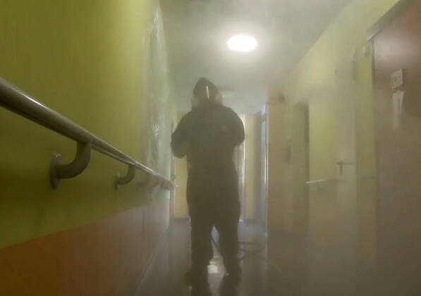 LOMBARDY, ITALY - APRIL 9, 2020: A video screen grab shows a serviceman of the Russian Nuclear, Biological and Chemical Protection Troops carrying out disinfection procedures at the Pope John Paul I care home in Seriate to the south-east of Bergamo. As agreed by Russia s President Vladimir Putin and Italy s Prime Minister Giuseppe Conte, 15 military aircraft have arrived in Italy, carrying around 100 Russian military virologists and Defence Ministry experts in epidemiology, eight medical teams for COVID-19 patients and disinfection equipment. Russian Defence Ministry TASS  TS0D4EDB