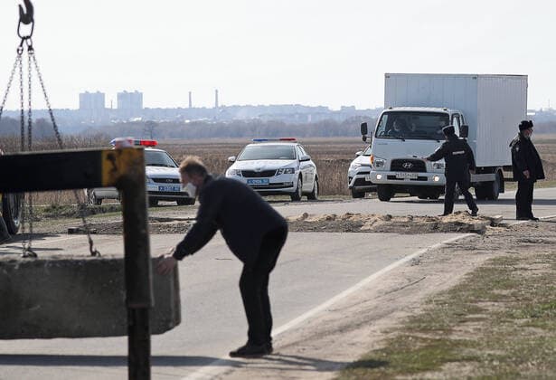 RYAZAN REGION, RUSSIA - APRIL 9, 2020: Placing a concrete obstacle at a checkpoint at an entrance to the village of Zaokskoye where several cases of the COVID-19 coronavirus infection were registered. The villages of Zaokskoye and Korostovo, Ryazan Region, have been put into lockdown from April 8 till April 22, 2020, to prevent the spread of the virus. Despite the novel coronavirus pandemic residents of the villages had been going to Moscow to sell dairy products, which, according to the local residents, led to the outbreak in the villages. Alexander Ryumin TASS  TS0D5087
