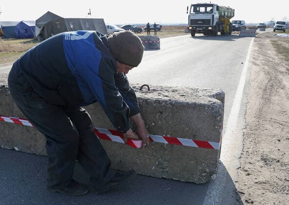 RYAZAN REGION, RUSSIA - APRIL 9, 2020: Placing a concrete obstacle at a checkpoint at an entrance to the village of Zaokskoye where several cases of the COVID-19 coronavirus infection were registered. The villages of Zaokskoye and Korostovo, Ryazan Region, have been put into lockdown from April 8 till April 22, 2020, to prevent the spread of the virus. Despite the novel coronavirus pandemic residents of the villages had been going to Moscow to sell dairy products, which, according to the local residents, led to the outbreak in the villages. Alexander Ryumin TASS  TS0D50A7