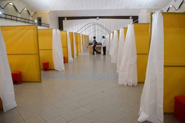 April 8, 2020, Nairobi, Nairobi, Kenya: A woman in a face mask is seen walking past a health worker at the yet to be used COVID-19 field hospital at The Aga Khan University Hospital in Nairobi, Kenya. The field hospital will be used to treat persons who test positive for the Coronavirus. Nairobi Kenya - ZUMAs197 20200408_zaa_s197_180 Copyright: xSOPAxImagesx