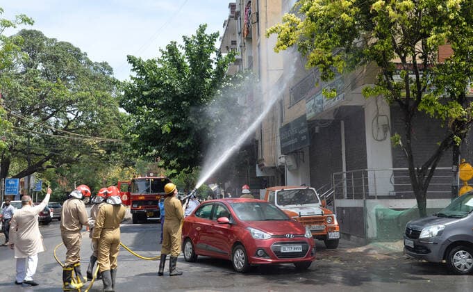 India: Disinfecting residential area against coronavirus A Fireman wearing protective gear sprays disinfectant in a residential area in New Delhi, India as the Covid-19 Corona Virus cases continue to go up daily. New Delhi India Copyright: SondeepxShankar