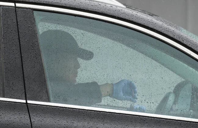 April 9, 2020, Los Angeles, California, U.S: A man prepares to swab his mouth during a drive-through COVID-19 testing in a parking lot of the Rose Bowl in Pasadena, California on Thursday, April 9, 2020. Los Angeles U.S. - ZUMAc68_ 20200409_zaf_c68_013 Copyright: xRingoxChiux