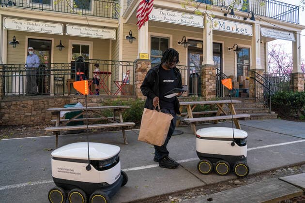 April 9, 2020: Anthony, a Broad Branch Market employee places a custom order of groceries into Starship Technologies robot for delivery in Washington, DC on Thursday, April 9, 2020. Broad Branch Market has closed their store due to COVID 19 and operating with phone-in orders, purchasing small items at the window and using Starship Technologies for robotic deliveries of food to the neighborhood. - ZUMAc206 20200409_zap_c206_007 Copyright: xKenxCedenox