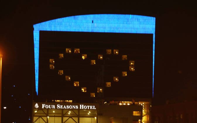 Lumiere Place Casino and Four Seasons Hotel is bathed in blue with a big heart, beginning today in St. Louis Thursday, April 9, 2020. Many buildings in St. Louis are lit in blue in support of the LightItBlue campaign. The initiative, which originated in the United Kingdom, calls for buildings, bridges and landmarks with the capability to turn their lights blue as a show of gratitude to those health care professionals and essential workers caring for people on the front lines during the COVID-19 pandemic.  SLP2020040903 BILLxGREENBLATT