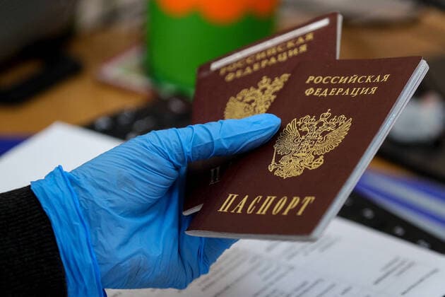MOSCOW, RUSSIA - APRIL 10, 2020: An employee holds passports during a marriage registration at the Tagansky registry office. Since March 27, 2020, people can submit applications for a marriage registration in Moscow only by phone or a public services portal, and the Moscow registry offices and wedding palaces do not hold ceremonies with guests. Sergei Bobylev TASS  TS0D5328