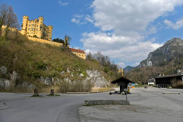 09.04.2020, Füssen im Allgäu, Negative Auswirkungen wegen der Corona-Virus-Pandemie auf den Tourismus im Allgäu, normal ein Touristen-Hotspot, die Schlösser in Bayern sind jetzt alle verwaist, hier Schloss Hohenschwangau. Der Parkplatz ohne ein Auto. 09.04.2020, Auswirkungen Tourismus wegen Corona-Virus 09.04.2020, Auswirkungen Tourismus wegen Corona-Virus