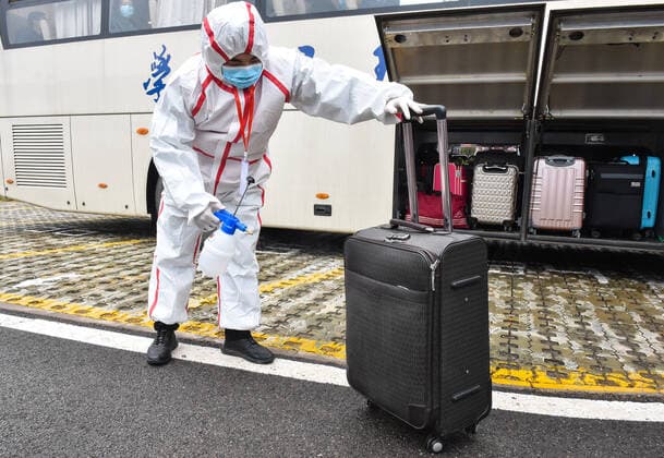 (200410) -- TAIYUAN, April 10, 2020 -- A volunteer disinfects luggages for students of Taiyuan University of Technology at the Taiyuan South Railway Station in Taiyuan, north China s Shanxi Province, April 10, 2020. The first batch of graduating students and post-graduates and doctorial students with research tasks in Shanxi resumed classes from Friday. ) CHINA-SHANXI-UNIVERSITY-CLASS-RESUMPTION (CN) ChaixTing 