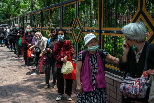 April 10, 2020, Hong Kong, China: Homeless people in a queue to receive free meals during the coronavirus pandemic..As the coronavirus pandemic worsens, thousands of Hong Kong residents who live in cramped coffin homes or homeless situation are struggling to adjust to their new reality. Coronavirus cases in Hong Kong are close to the 1,000 mark. Hong Kong China - ZUMAs197 20200410_zaa_s197_023 Copyright: xSOPAxImagesx