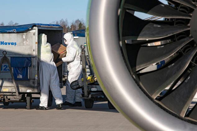 (200410) -- RIGA, April 10, 2020 -- Workers unload personal protection equipment (PPE) from China to help curb the spread of the novel coronavirus disease (COVID-19), in Riga, Latvia on April 10, 2020. (Photo by Xinhua) LATVIA-RIGA-COVID-19-PPE EdijsxPalens 