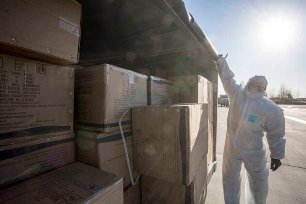 (200410) -- RIGA, April 10, 2020 -- A worker unloads personal protection equipment (PPE) from China to help curb the spread of the novel coronavirus disease (COVID-19), in Riga, Latvia on April 10, 2020. (Photo by Xinhua) LATVIA-RIGA-COVID-19-PPE EdijsxPalens 
