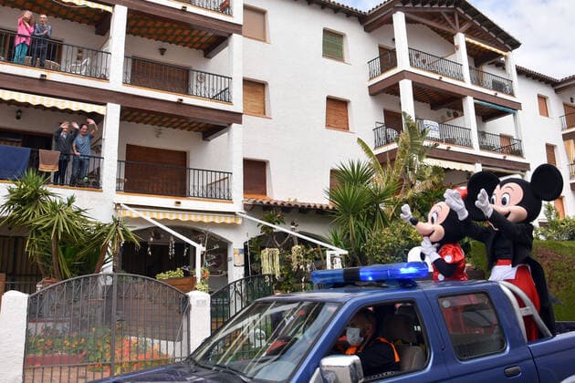 April 10, 2020, Vendrell, Spain: Civil Protection Volunteers from El Vendrell dressed as Mickey and Minnie Mouse greet people who are confined in their houses during the coronavirus crisis..Volunteers from Civil Protection of El Vendrell, two of them disguised as Disney characters, Mickey Mouse and Minnie Mouse have toured the streets of the city to cheer up the neighbours and the children who are in their homes, serving the confinement due the Covid-19 health crisis. Vendrell Spain - ZUMAs197 20200410_zaa_s197_048 Copyright: xRamonxCostax