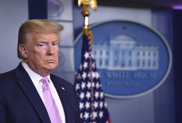 President Donald Trump listens at a Coronavirus briefing at the White House on Friday, April 10, 2020, in Washington, DC. With the U.S. death toll from the coronavirus pandemic expected to peak over the weekend, most of the country will be firmly under stay-at-home orders on Easter Sunday.  WAS2020410522 KEVINxDIETSCH