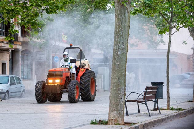 20200410 Corona Lock Down PALMA DE MALLORCA, SPAIN - APRIL 10 2020 : Tractor disinfects streets in Llucmajor in Mallorca at - Corona Lock Down on April 10, 2020 in Palma de Mallorca, . Palma de Mallorca Baleares Spain