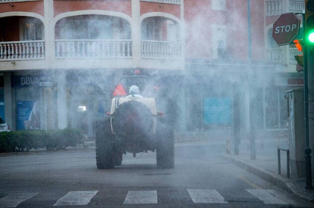20200410 Corona Lock Down PALMA DE MALLORCA, SPAIN - APRIL 10 2020 : Tractor disinfects streets in Llucmajor in Mallorca at - Corona Lock Down on April 10, 2020 in Palma de Mallorca, . Palma de Mallorca Baleares Spain