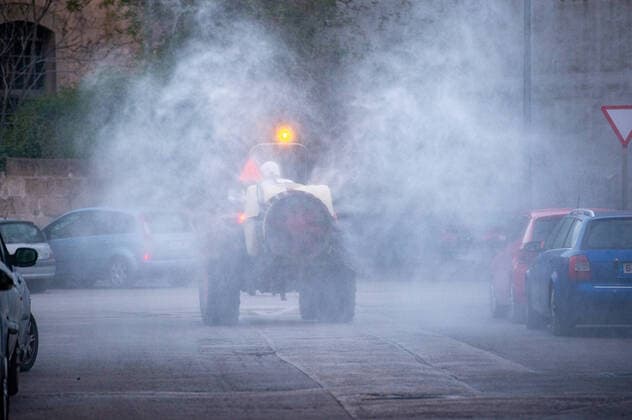 20200410 Corona Lock Down PALMA DE MALLORCA, SPAIN - APRIL 10 2020 : Tractor disinfects streets in Llucmajor in Mallorca at - Corona Lock Down on April 10, 2020 in Palma de Mallorca, . Palma de Mallorca Baleares Spain
