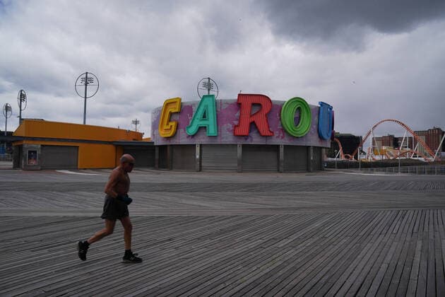 April 10, 2020, New York, NY, USA: A man jogs on a deserted boardwalk in the Coney Island section of the Borough of Brooklyn on April 10, 2020 in New York. New York USA - ZUMAb148 20200410_zap_b148_125 Copyright: xBryanxSmithx